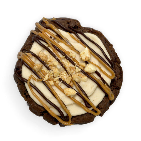 PB Chocolate Dream cookie topped with peanut butter buttercream, ganache, and crushed peanuts. Gluten-free, vegan, soy-free.