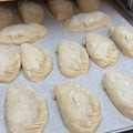 Gluten-free Chicken Comfort Hand Pies being prepared on a baking tray at Sinful Confections bakery in Portland Oregon