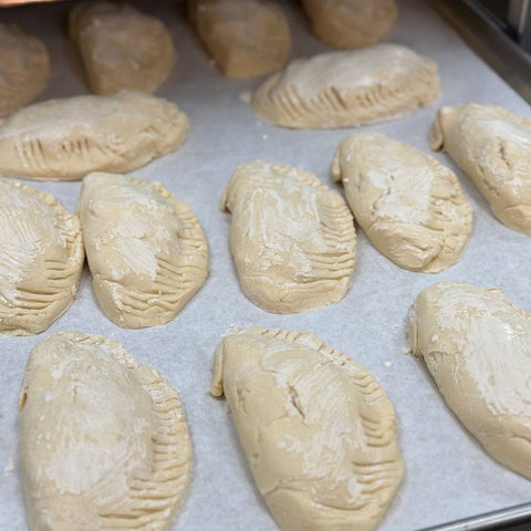 Gluten-free Chicken Comfort Hand Pies being prepared on a baking tray at Sinful Confections bakery in Portland Oregon