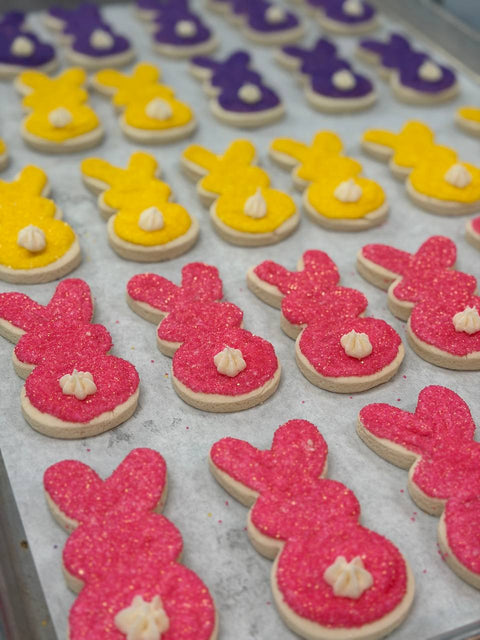Decorated gluten-free and vegan Easter bunny sugar cookies with icing tails and colored sugar at Sinful Confections Portland bakery