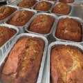 Gluten free and dairy free pumpkin bread mini loaves cooling in foil pans, golden brown with a soft, moist texture