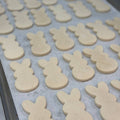 Gluten-free and vegan Easter bunny sugar cookies unfrosted on baking tray at Sinful Confections Portland