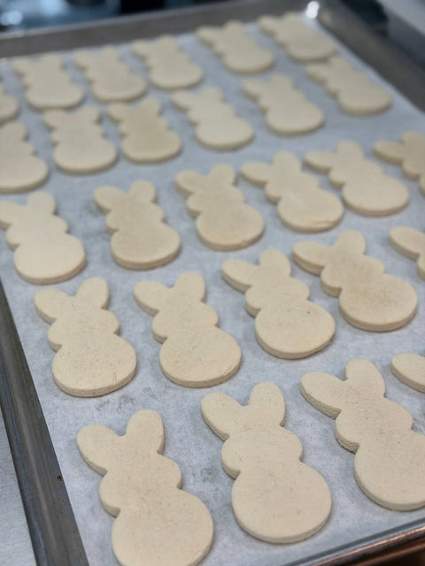 Gluten-free and vegan Easter bunny sugar cookies unfrosted on baking tray at Sinful Confections Portland