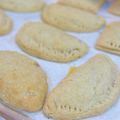 Multiple gluten-free ham and cheese hand pies baked to a golden crust