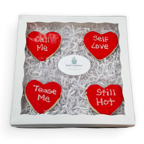 Heart-shaped Valentine’s cookie cake decorated with vanilla frosting, pink sprinkles, and “love” icing, gluten-free and dairy-free from Sinful Confections in Portland, Oregon