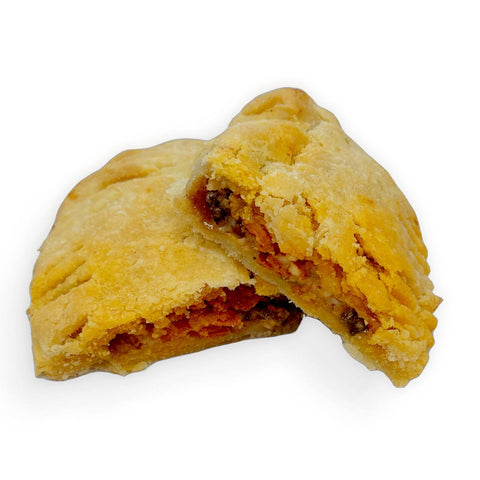 Gluten-free pepperoni pizza popper hand pie from Sinful Confections bakery filled with bacon, pepperoni, jalapeños, and pizza sauce in a flaky crust