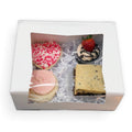 V-Day Temptation Box featuring a cookie dough brownie, heart-shaped sugar cookie, loaded cookie, and strawberry lava cupcake, gluten-free and dairy-free from Sinful Confections